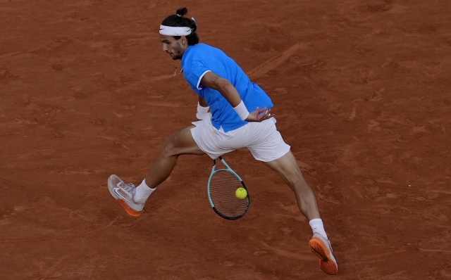 Lorenzo Musetti of Italy returns a shot to Felix Auger-Aliassime of Canada during their men's singles bronze medal match, at the 2024 Summer Olympics, Saturday, Aug. 3, 2024, at the Roland Garros stadium in Paris, France. (AP Photo/Andy Wong)