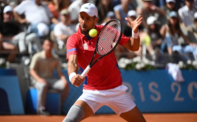 epa11525105 Novak Djokovic of Serbia in action against Carlos Alcaraz of Spain during the Men Singles gold medal match of the Tennis competitions in the Paris 2024 Olympic Games, at the Roland Garros in Paris, France, 04 August 2024.  EPA/CAROLINE BLUMBERG