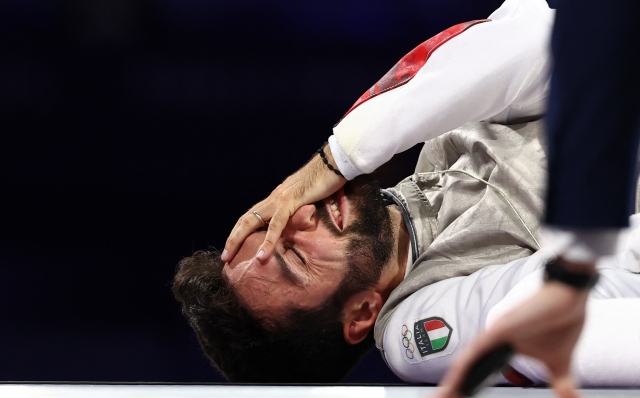 Italy's Guillaume Bianchi (L) reacts in the men's foil team gold medal bout between Italy and Japan during the Paris 2024 Olympic Games at the Grand Palais in Paris, on August 4, 2024. (Photo by Franck FIFE / AFP)