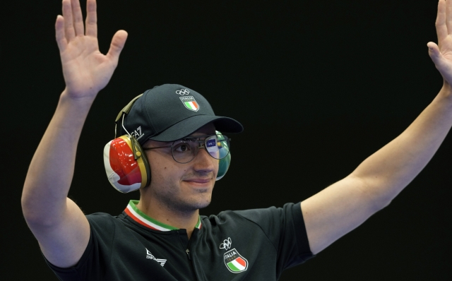 Italy's Massimo Spinella gestures as he is introduced before the 25m rapid fire pistol men's final at the 2024 Summer Olympics, Monday, Aug. 5, 2024, in Chateauroux, France. (AP Photo/Manish Swarup)