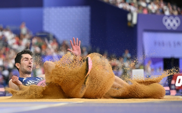 Greece's Miltiadis Tentoglou competes in the men's long jump final of the athletics event at the Paris 2024 Olympic Games at Stade de France in Saint-Denis, north of Paris, on August 6, 2024. (Photo by Andrej ISAKOVIC / AFP)