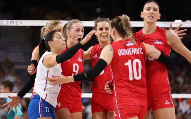 PARIS, FRANCE - AUGUST 06: Aleksandra Uzelac #9 of Team Serbia reacts with teammates during a Women's Quarterfinals match against Team Italy on day eleven of the Olympic Games Paris 2024 at Paris Arena on August 06, 2024 in Paris, France. (Photo by Clive Brunskill/Getty Images)