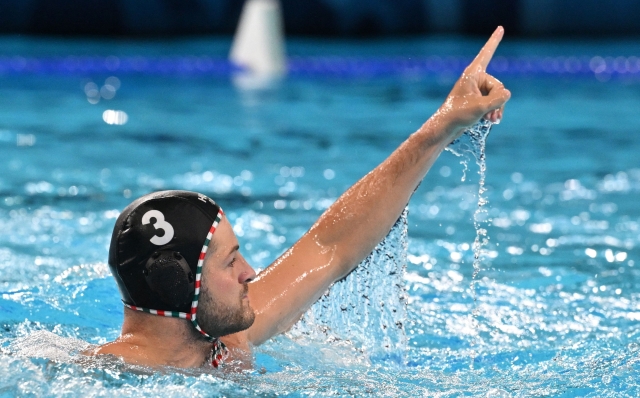 Hungary's #03 Krisztian Manhercz celebrates after scoring in the men's water polo preliminary round group B match between Australia and Hungary during the Paris 2024 Olympic Games at the Aquatics Centre in Saint-Denis, north of Paris, on August 3, 2024. (Photo by Andreas SOLARO / AFP)