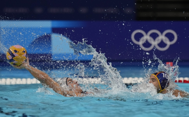 Italy's Matteo Rocchi Gratta battles for the ball with Spain's Felipe Perrone Rocha during a men's 5th and 8th place classification match between Italy and Spain, at the 2024 Summer Olympics, Friday, Aug. 9, 2024, in Paris. (AP Photo/Luca Bruno)