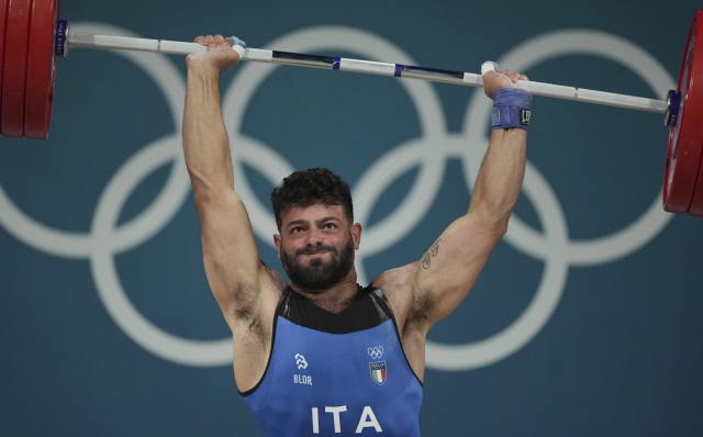 Antonino Pizzolato of Italy competes during the men's 89kg weightlifting event, at the 2024 Summer Olympics, Friday, Aug. 9, 2024, in Paris, France. (AP Photo/Kin Cheung)