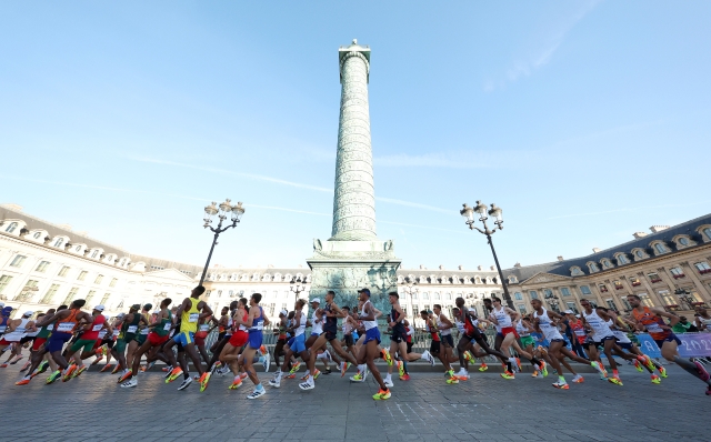 PARIS, FRANCE - AUGUST 10: Athletes run past Place Vendome during the Men's Marathon during day fifteen of the Olympic Games Paris 2024 at Esplanade Des Invalides on August 10, 2024 in Paris, France. (Photo by Patrick Smith/Getty Images)