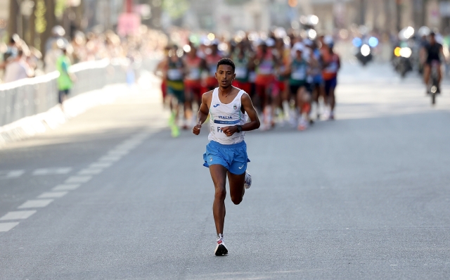 PARIS, FRANCE - AUGUST 10: Eyob Faniel of Team Italy competes ahead of the trailing pack during the Men's Marathon during day fifteen of the Olympic Games Paris 2024 at Esplanade Des Invalides on August 10, 2024 in Paris, France. (Photo by Cameron Spencer/Getty Images)