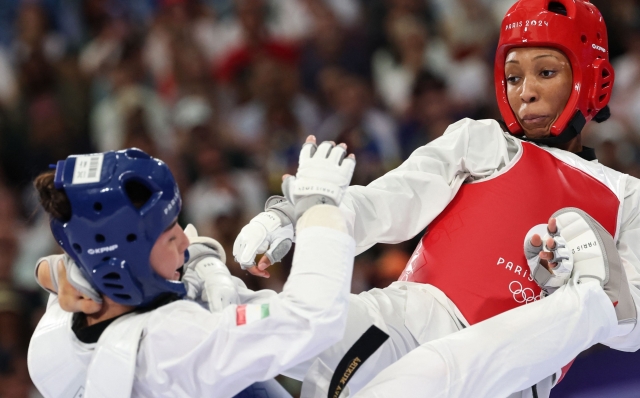 France's Althea Laurin (R) competes against Tajikistan's Munira Abdusalomova in the taekwondo women's +67kg round of 16 bout of the Paris 2024 Olympic Games at the Grand Palais in Paris on August 10, 2024. (Photo by David GRAY / AFP)