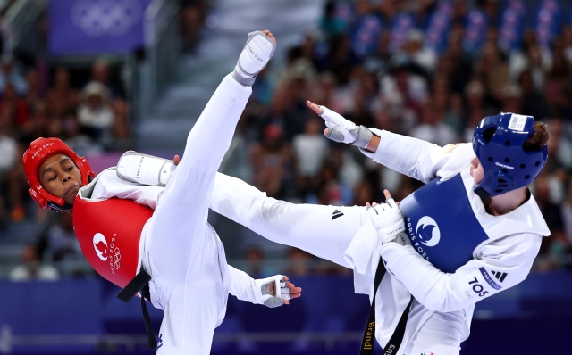 PARIS, FRANCE - AUGUST 10: Arlettys Herrera of Team Cuba and Lorena Brandl of Team Germany compete during the Women +67kg Round of 16 match between Arlettys Herrera of Team Cuba and Lorena Brandl of Team Germany on day fifteen of the Olympic Games Paris 2024 at Grand Palais on August 10, 2024 in Paris, France. (Photo by Buda Mendes/Getty Images)