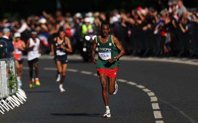 PARIS, FRANCE - AUGUST 10: Tamirat Tola of Team Ethiopia competes during the Men's Marathon during day fifteen of the Olympic Games Paris 2024 at Esplanade Des Invalides on August 10, 2024 in Paris, France. (Photo by Cameron Spencer/Getty Images)