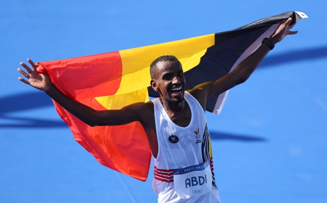 PARIS, FRANCE - AUGUST 10: Silver medalist Bashir Abdi of Team Belgium celebrates following the Men's Marathon on day fifteen of the Olympic Games Paris 2024 at Esplanade Des Invalides on August 10, 2024 in Paris, France. (Photo by Hannah Peters/Getty Images)