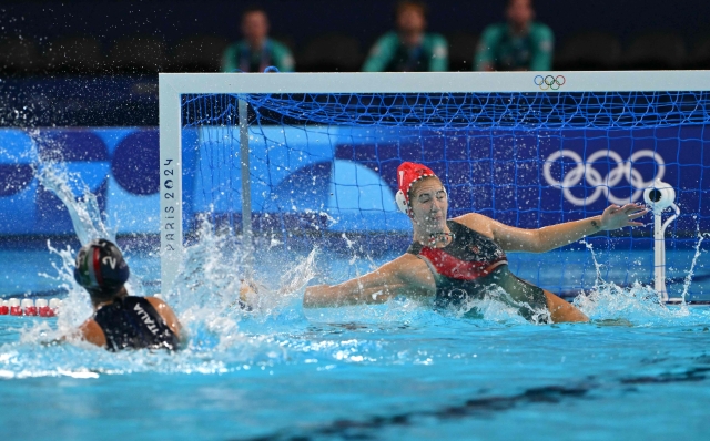 Hungary's #01 Alda Magyari saves a penalty by  in the women's water polo 5th-6th classification match between Hungary and Italy during the Paris 2024 Olympic Games at the Paris La Defense Arena in Paris on August 10, 2024. (Photo by Andreas SOLARO / AFP)