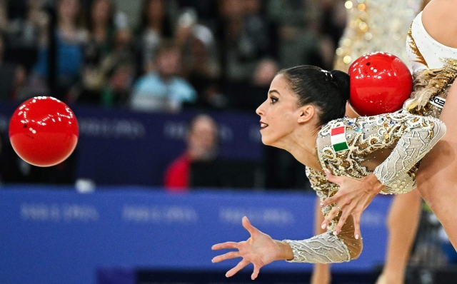 Italy's gymnasts perform with the balls and ribbons as they compete in the rhytmic gymnastics' group all-around final during the Paris 2024 Olympic Games at the Porte de la Chapelle Arena in Paris, on August 10, 2024. (Photo by Gabriel BOUYS / AFP)