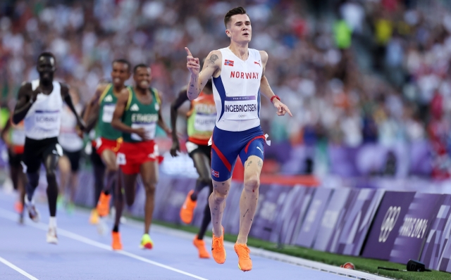 PARIS, FRANCE - AUGUST 10: Jakob Ingebrigtsen of Team Norway celebrates winning the Gold medal in Men's 5000m Final on day fifteen of the Olympic Games Paris 2024 at Stade de France on August 10, 2024 in Paris, France. (Photo by Hannah Peters/Getty Images)