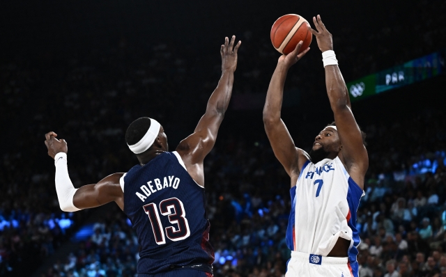 France's #07 Guerschon Yabusele takes a shot over USA's #13 Bam Adebayo in the men's Gold Medal basketball match between France and USA during the Paris 2024 Olympic Games at the Bercy  Arena in Paris on August 10, 2024. (Photo by Aris MESSINIS / AFP)