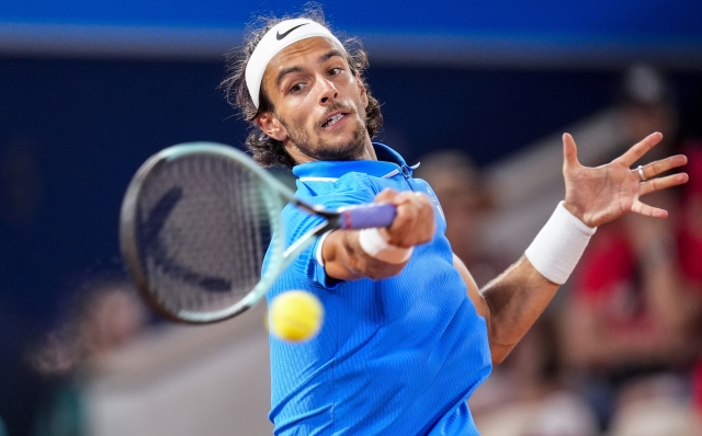 Lorenzo Musetti of Italy returns the ball against Felix Auger-Aliassime of Canada during men's singles bronze medal tennis match at the Roland Garros stadium, at the 2024 Summer Olympics, Saturday, Aug. 3, 2024, in Paris, France. (AP Photo/Manu Fernandez)