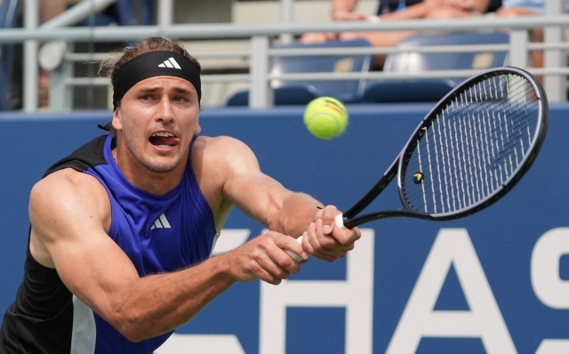 Germany's Alexander Zverev hits a backhand return to Germany's Maximilian Marterer during their men's singles first round tennis match on day one of the US Open tennis tournament at the USTA Billie Jean King National Tennis Center in New York City, on August 26, 2024. (Photo by TIMOTHY A. CLARY / AFP)