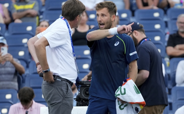 Corentin Moutet, of France, speaks with an official during a match against Sebastian Korda, of the United States, in the first round of the U.S. Open tennis championships, Tuesday, Aug. 27, 2024, in New York. (AP Photo/Frank Franklin II)