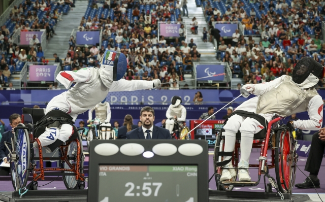 Italy's Beatrice Maria Vio Grandis, left, competes against China's Xiao Rong during the women's foil wheelchair fencing semifinal at the 2024 Paralympics, Wednesday, Sept. 4, 2024, in Paris, France. (AP Photo/Thomas Padilla)