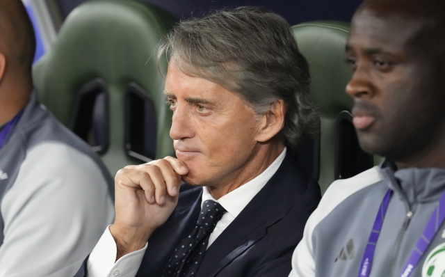 Saudi Arabia's head coach Roberto Mancini sits in his team dugout prior to the Asian Cup round of 16 soccer match between Saudi Arabia and South Korea at Education City Stadium Al Rayyan, Qatar, Tuesday, Jan. 30, 2024. (AP Photo/Aijaz Rahi)