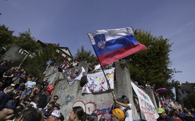 Fans wave the Slovenian flag during the Men Elite road race of the Cycling and Para-cycling Road World Championships in Zurich, Switzerland, Sunday, Sept. 29, 2024. (AP Photo/Peter Dejong)