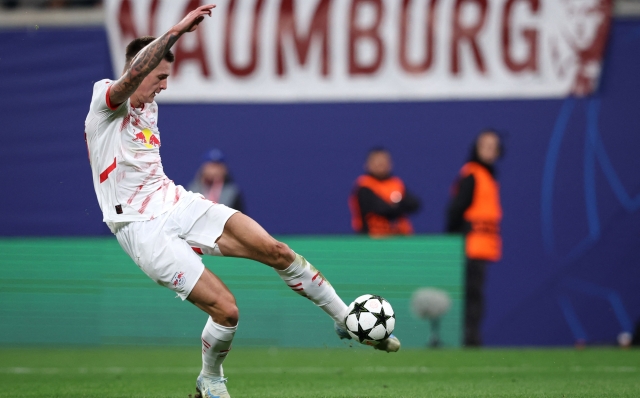 RB Leipzig's Slovenian forward #30 Benjamin Sesko kicks the ball and scores during the UEFA Champions League football match between RB Leipzig and Juventus FC at the Red Bull Arena in Leipzig on October 2, 2024. (Photo by Ronny HARTMANN / AFP)