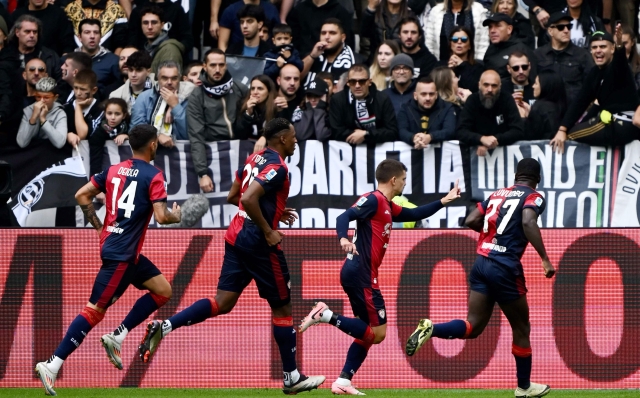 Cagliaris Romanian midfielder #18 Razvan Marin (2R) celebrates with teammates after scoring a goal during the Italian Serie A football match between Juventus and Cagliari at the Allianz stadium in Turin on October 6, 2024. (Photo by MARCO BERTORELLO / AFP)