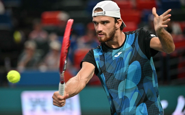 Czech Republic's Tomas Machac hits a return to Italy's Jannik Sinner during their men's singles semi-final match at the Shanghai Masters tennis tournament in Shanghai on October 12, 2024. (Photo by HECTOR RETAMAL / AFP)