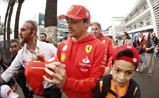 MEXICO CITY, MEXICO - OCTOBER 26: Charles Leclerc of Monaco and Ferrari signs autographs for fans in the Paddock prior to final practice ahead of the F1 Grand Prix of Mexico at Autodromo Hermanos Rodriguez on October 26, 2024 in Mexico City, Mexico. (Photo by Chris Graythen/Getty Images)