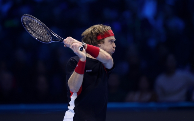 TURIN, ITALY - NOVEMBER 15: Andrey Rublev plays a backhand against Casper Ruud of Norway during the Men's Singles Group Stage match during day six of the Nitto ATP finals 2024 at Inalpi Arena on November 15, 2024 in Turin, Italy. (Photo by Clive Brunskill/Getty Images)