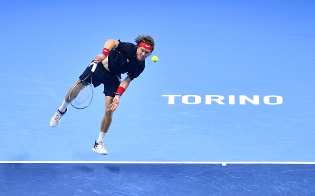 TURIN, ITALY - NOVEMBER 15: Andrey Rublev serves against Casper Ruud of Norway during the Men's Singles Group Stage match during day six of the Nitto ATP finals 2024 at Inalpi Arena on November 15, 2024 in Turin, Italy. (Photo by Valerio Pennicino/Getty Images)