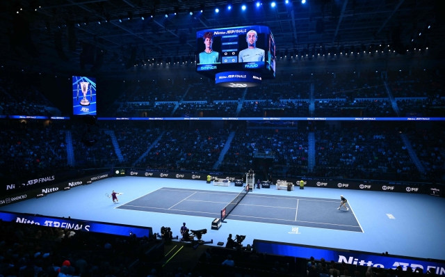 Norway's Casper Ruud (L) hits a return to Italy's Jannik Sinner during their semi-final match at the ATP Finals tennis tournament in Turin on November 16, 2024. (Photo by Marco BERTORELLO / AFP)