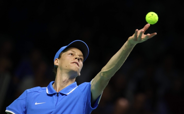 Jannik Sinner of Team Italy serves against Sebastian Baez of Team Argentina during their quarter-final singles match between Italy and Argentina at the Davis Cup Finals at the Palacio de Deportes Jose Maria Martin Carpena arena in Malaga, southern Spain, on November 21, 2024. (Photo by Thomas COEX / AFP)