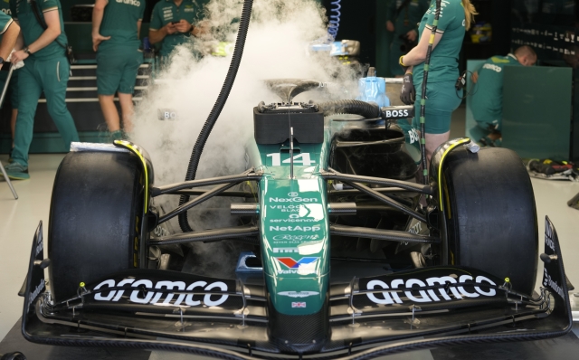 Aston Martin driver Fernando Alonso of Spain is covered in smoke ahead of practice at the Lusail International Circuit in Lusail, Qatar, ahead of the Qatar Formula One Grand Prix, Friday, Nov. 29, 2024. (AP Photo/Darko Bandic)