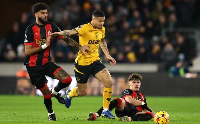 WOLVERHAMPTON, ENGLAND - NOVEMBER 30: Joao Gomes of Wolverhampton Wanderers is challenged by Philip Billing and Milos Kerkez of AFC Bournemouth during the Premier League match between Wolverhampton Wanderers FC and AFC Bournemouth at Molineux on November 30, 2024 in Wolverhampton, England. (Photo by Michael Steele/Getty Images)