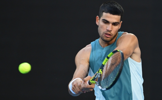 MELBOURNE, AUSTRALIA - JANUARY 13: Carlos Alcaraz of Spain warms up prior to the Men's Singles First Round match against Alexander Shevchenko of Kazakhstan during day two of the 2025 Australian Open at Melbourne Park on January 13, 2025 in Melbourne, Australia. (Photo by Quinn Rooney/Getty Images)