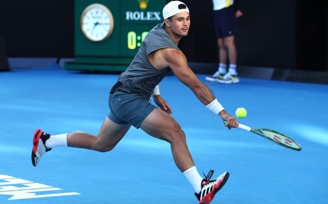 USA?s Marcos Giron hits a return against Italy's Jannik Sinner during their men's singles match on day seven of the Australian Open tennis tournament in Melbourne on January 18, 2025. (Photo by DAVID GRAY / AFP) / -- IMAGE RESTRICTED TO EDITORIAL USE - STRICTLY NO COMMERCIAL USE --