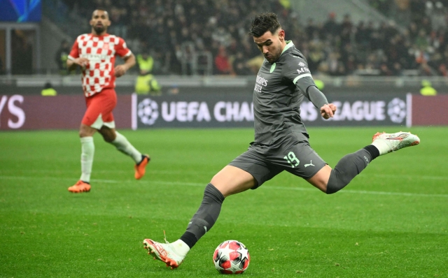 AC Milan's French defender #19 Theo Hernandez kicks the ball during the UEFA Champions League football match between AC Milan and Girona at San Siro stadium in Milan, on January 22, 2025. (Photo by Alberto PIZZOLI / AFP)