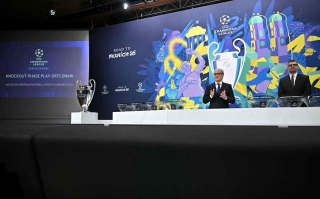 UEFA Deputy General Secretary Giorgio Marchetti (L) and UEFA Managing Director of Communications Pedro Pinto host the 2024-2025 UEFA Champions League football tournament knockout play-off draw at the House of European football in Nyon, on January 31, 2025. (Photo by Fabrice COFFRINI / AFP)