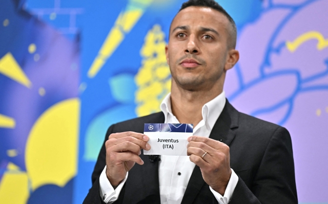 Former Spanish player Thiago Alcantara holds the paper slip of Juventus during the 2024-2025 UEFA Champions League football tournament knockout play-off draw at the House of European football in Nyon, on January 31, 2025. (Photo by Fabrice COFFRINI / AFP)