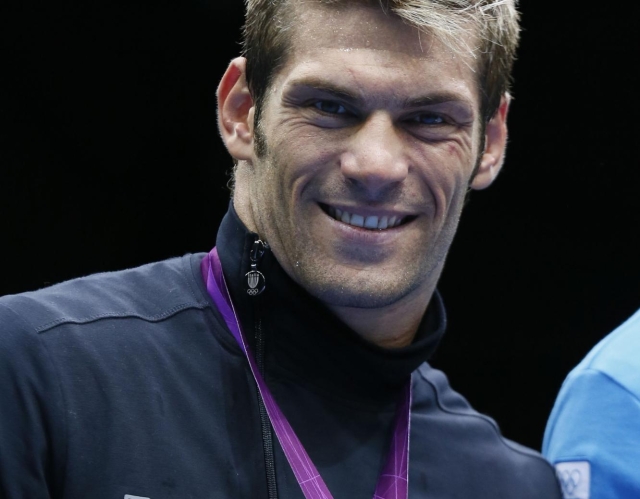 Silver medalist Clemente Russo of Italy celebrates during the awards ceremony for the Heavyweight (91kg) boxing category of the 2012 London Olympic Games at the ExCel Arena August 11, 2012 in London. AFP PHOTO / Jack GUEZ