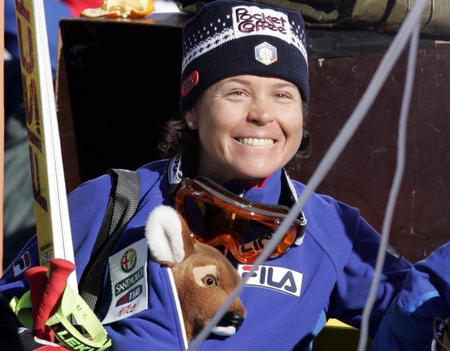 Isolde Kostner of Italy holds a deer mascot as she smiles after completing the Women's Super-G at the World Alpine Ski Championships in Santa Caterina Valfurva, Italy, Sunday, Jan. 30, 2005. (AP Photo/Luca Bruno)