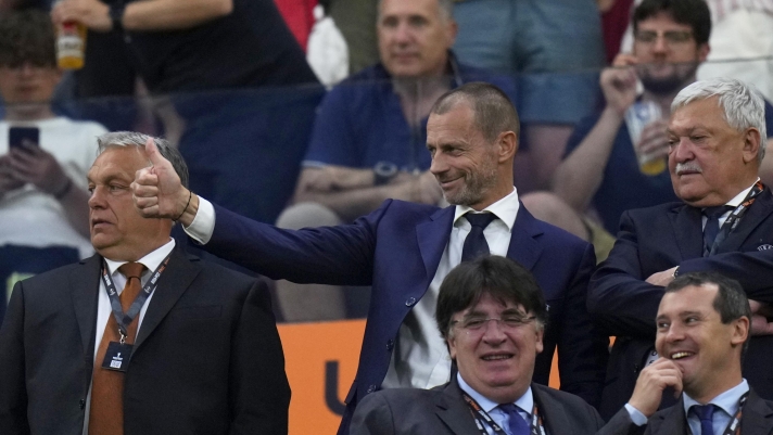 UEFA president Aleksander Ceferin, center, gestures next to Hungarian Prime Minster Viktor Orban, left, on the stands during the Europa League final soccer match between Sevilla and Roma, at the Puskas Arena in Budapest, Hungary, Wednesday, May 31, 2023. (AP Photo/Petr David Josek)