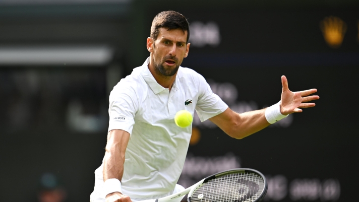 LONDON, ENGLAND - JULY 03: Novak Djokovic of Serbia plays a backhand against Pedro Cachin of Argentina in the Men's Singles first round match on day one of The Championships Wimbledon 2023 at All England Lawn Tennis and Croquet Club on July 03, 2023 in London, England. (Photo by Shaun Botterill/Getty Images)