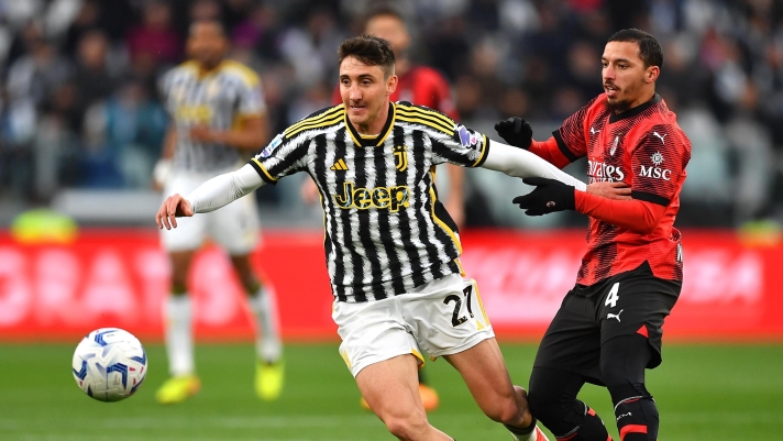 TURIN, ITALY - APRIL 27: Andrea Cambiaso of Juventus is challenged by Ismael Bennacer of AC Milan during the Serie A TIM match between Juventus and AC Milan at Allianz Stadium on April 27, 2024 in Turin, Italy. (Photo by Valerio Pennicino/Getty Images)