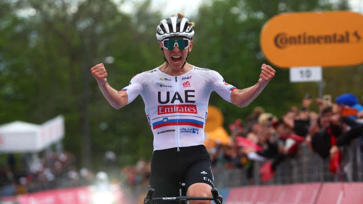 Team UAE's Slovenian rider Tadej Pogacar celebrates as he crosses the finish line to win the 2nd stage of the 107th Giro d'Italia cycling race, 161km between San Francesco al Campo and Sanctuary of Oropa (Biella), on May 5, 2024 in Biella. (Photo by Luca Bettini / AFP)