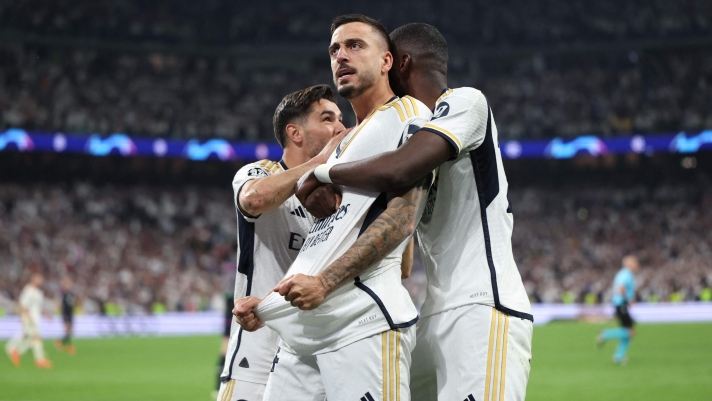 Real Madrid's Spanish forward #14 Joselu celebrates scoring with teammates during the UEFA Champions League semi final second leg football match between Real Madrid CF and FC Bayern Munich at the Santiago Bernabeu stadium in Madrid on May 8, 2024. (Photo by Thomas COEX / AFP)