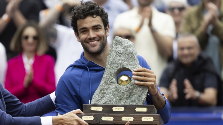 Italy's Matteo Berrettini holds the trophy after defeating France's Quentin Halys in the men's singles final of the Swiss Open tennis tournament in Gstaad, Switzerland, Sunday, July 21, 2024. (Peter Klaunzer/Keystone via AP)