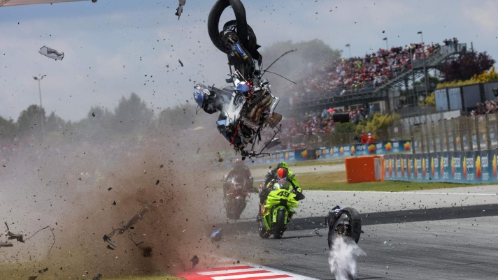 The motorcycle of Team Gresini Racing MotoGP's Alex Marquez hurls through the air as he crashes during the 2026 Catalunya Moto GP Grand Prix at the Catalunya racetrack in Montmelo, near Barcelona, on May 17, 2026. (Photo by DANIEL BALLARIN / AFP)