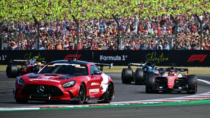 Ferrari's Monegasque driver Charles Leclerc (R), Mercedes' British driver George Russell (2R) and Ferrari's British driver Lewis Hamilton (L) tucked in behind the safety car (2L) during the Formula One British Grand Prix at the Silverstone motor racing circuit in Silverstone, central England, on July 5, 2026. (Photo by Ben STANSALL / AFP)
